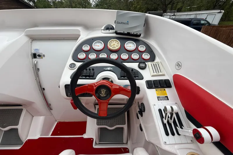 Slide: The Image of Cockpit of a 1998 Donzi 33 ZX boat with red accents and Garmin navigation system. - 15
