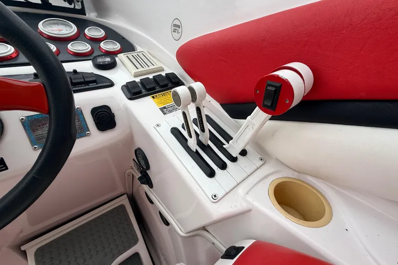 Slide: The Image of Interior cockpit of a 1998 Donzi 33 ZX boat with red and white controls. - 16