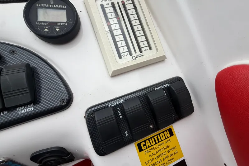 Slide: The Image of 1998 Donzi 33 ZX boat dashboard with depth gauge and control switches. - 17