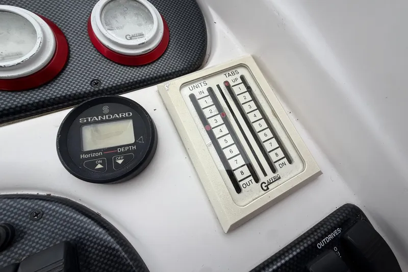 Slide: The Image of Control panel of a 1998 Donzi 33 ZX boat with depth gauge and trim tabs. - 18