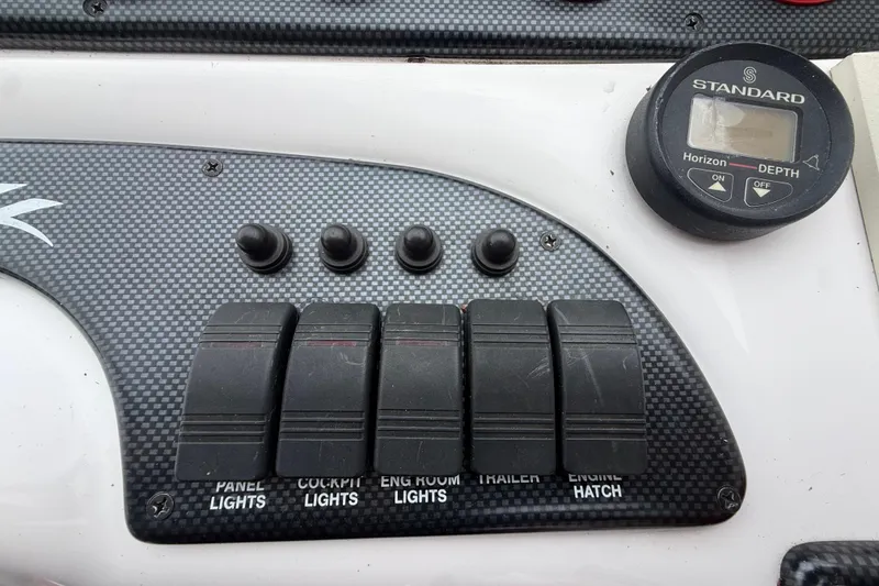 Slide: The Image of Control panel of a 1998 Donzi 33 ZX boat with switches and depth gauge. - 19