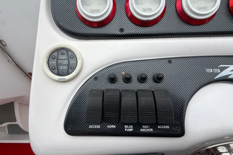 Slide: The Image of Control panel of a 1998 Donzi 33 ZX boat with switches and Clarion audio controls. - 20