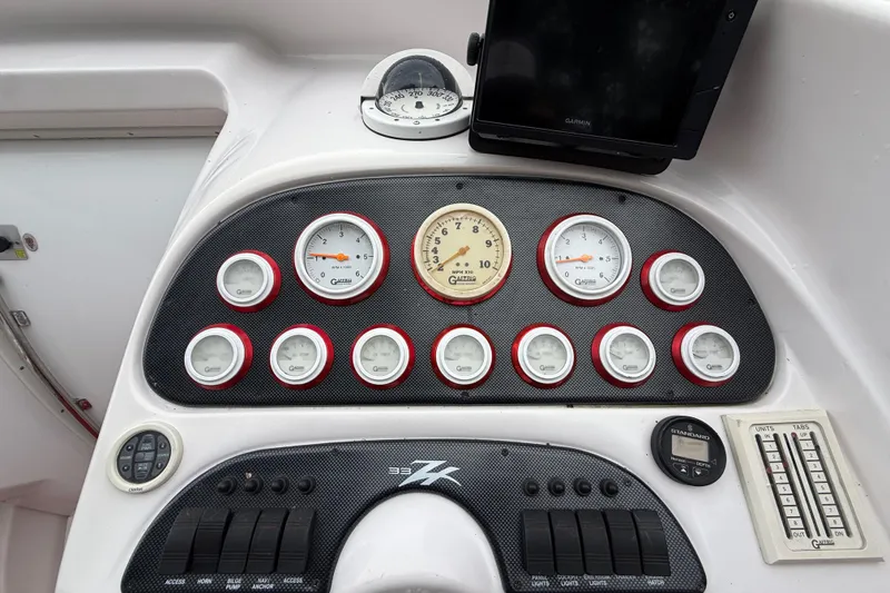 Slide: The Image of Dashboard of a 1998 Donzi 33 ZX boat with gauges and controls. - 22