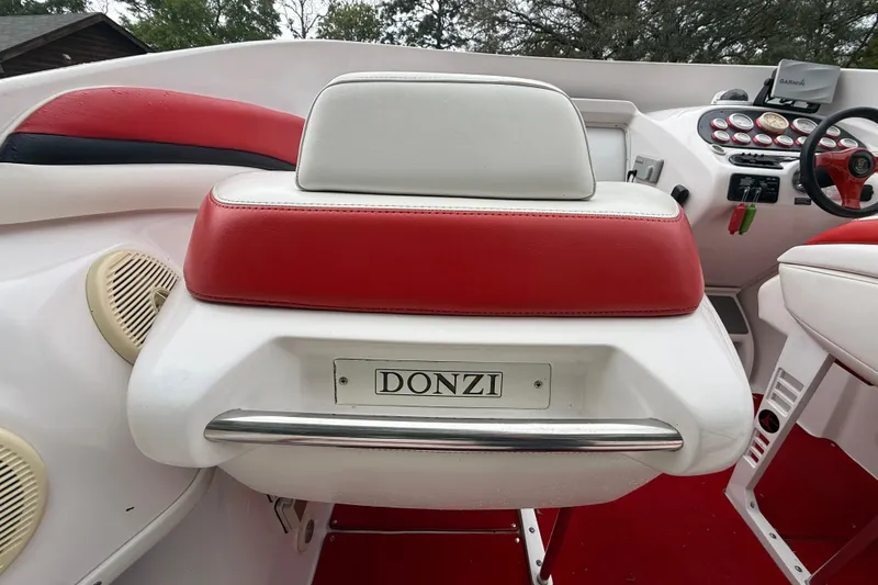 Slide: The Image of 1998 Donzi 33 ZX boat interior with red and white seating and dashboard controls. - 24