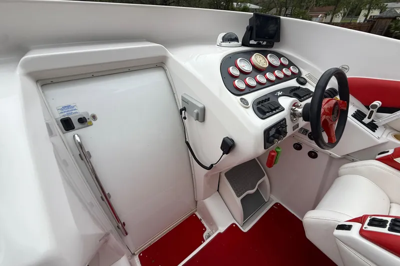 Slide: The Image of 1998 Donzi 33 ZX boat cockpit with red and white interior, steering wheel, and control panel. - 27