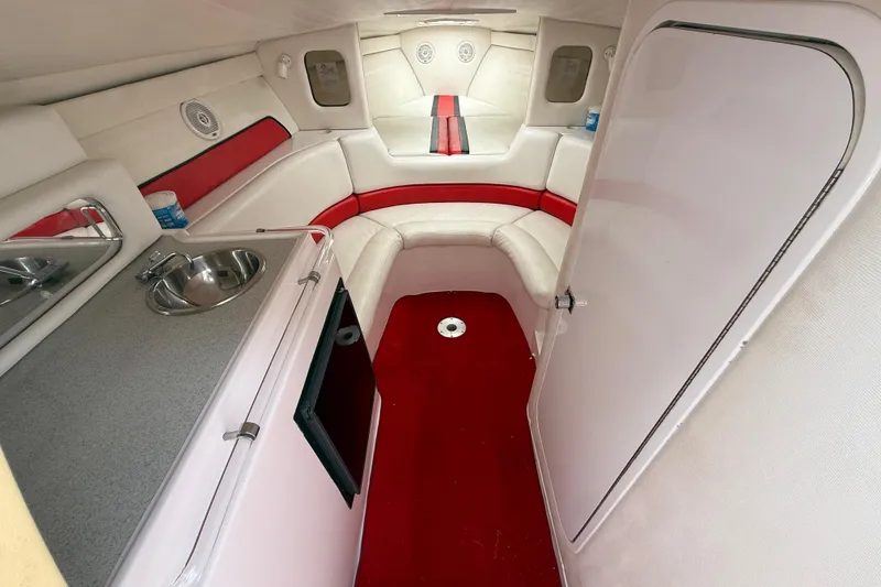 Slide: The Image of Interior of a 1998 Donzi 33 ZX boat with red and white seating and kitchenette. - 30