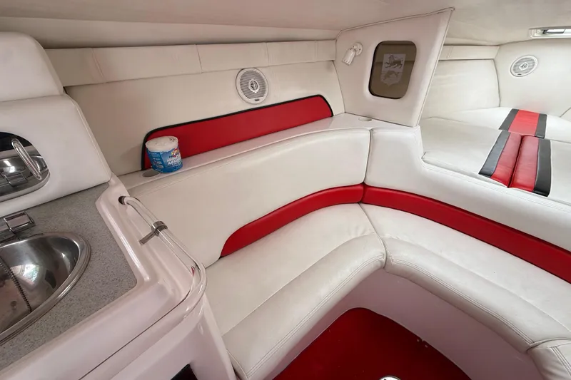 Slide: The Image of Interior of 1998 Donzi 33 ZX boat with white and red seating, compact sink. - 34