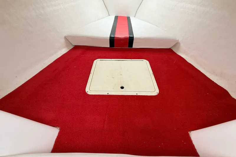 Slide: The Image of Interior of a 1998 Donzi 33 ZX boat with red carpet and white seating. - 37