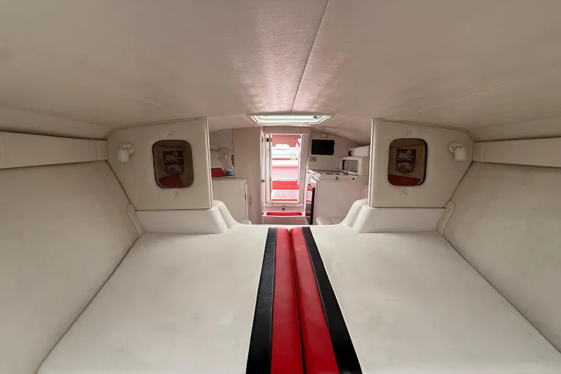 Slide: The Image of Interior of a 1998 Donzi 33 ZX boat, featuring white and red upholstery. - 38