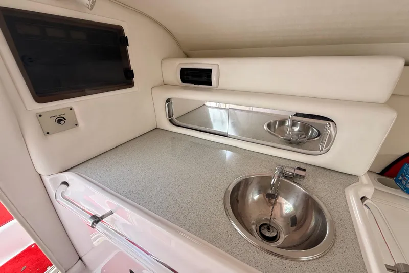 Slide: The Image of Interior of a 1998 Donzi 33 ZX boat featuring a sleek kitchenette with a sink. - 41