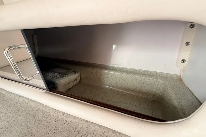 Slide: The Image of Storage compartment inside a 1998 Donzi 33 ZX boat, featuring a sleek handle design. - 42
