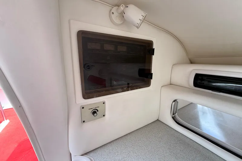 Slide: The Image of Interior of a 1998 Donzi 33 ZX boat, featuring control panel and lighting. - 44