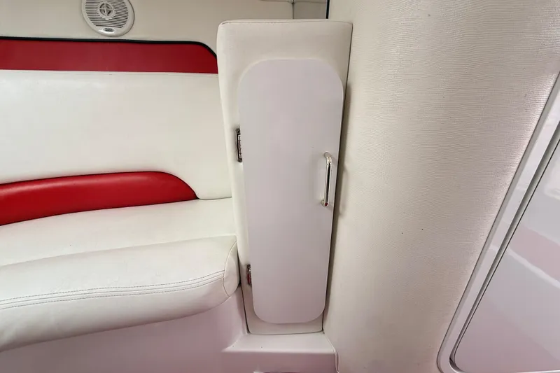 Slide: The Image of Interior of a 1998 Donzi 33 ZX boat, featuring white and red seating. - 46