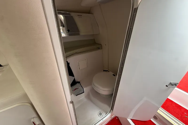 Slide: The Image of 1998 Donzi 33 ZX boat bathroom interior with toilet and mirror. - 49