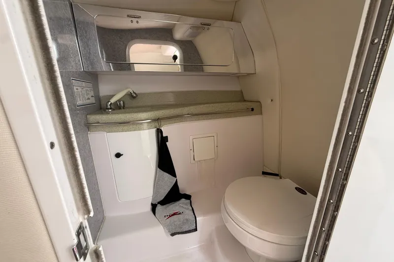 Slide: The Image of 1998 Donzi 33 ZX boat bathroom with sink, mirror, and toilet. - 50