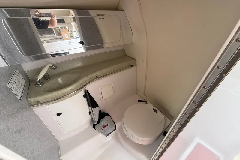 Slide: The Image of 1998 Donzi 33 ZX boat bathroom with sink, mirror, and toilet. - 51