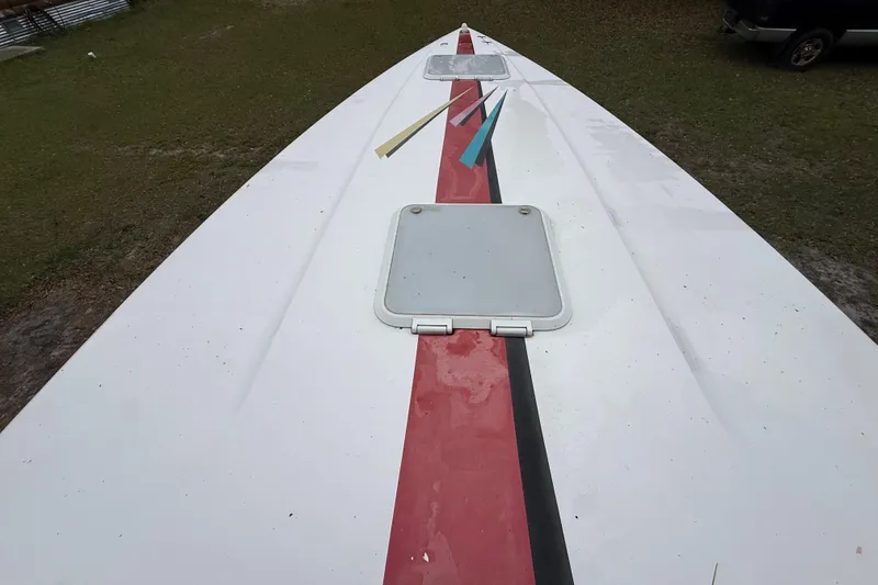 Slide: The Image of 1998 Donzi 33 ZX boat deck with red stripe and hatch, viewed from above. - 54