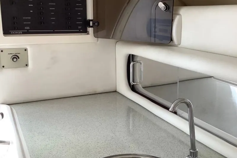 Slide: The Image of Interior of a 1998 Donzi 33 ZX boat featuring a sleek countertop and control panel. - 6