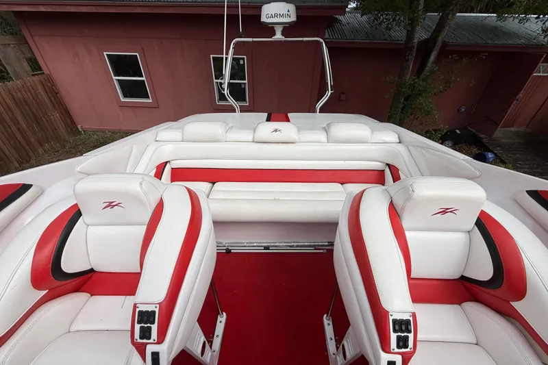 Slide: The Image of 1998 Donzi 33 ZX boat interior with red and white seating, featuring Garmin equipment. - 61