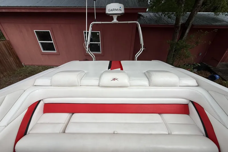 Slide: The Image of 1998 Donzi 33 ZX boat with white and red seating, Garmin radar visible. - 62