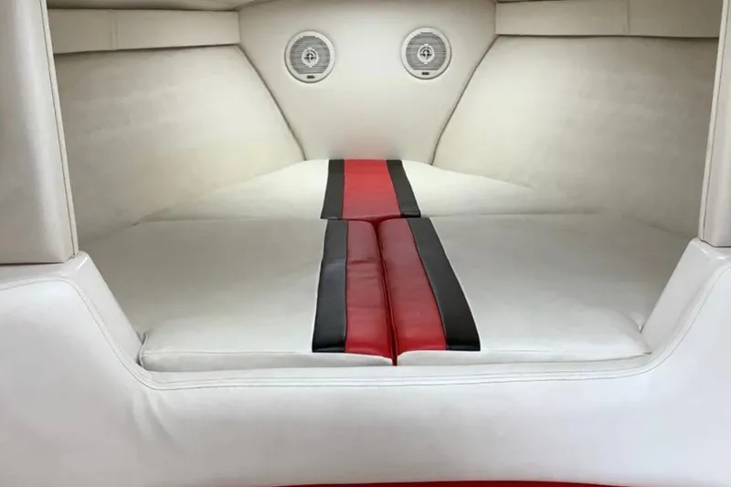 Slide: The Image of 1998 Donzi 33 ZX interior cabin with white and red upholstery, featuring built-in speakers. - 7