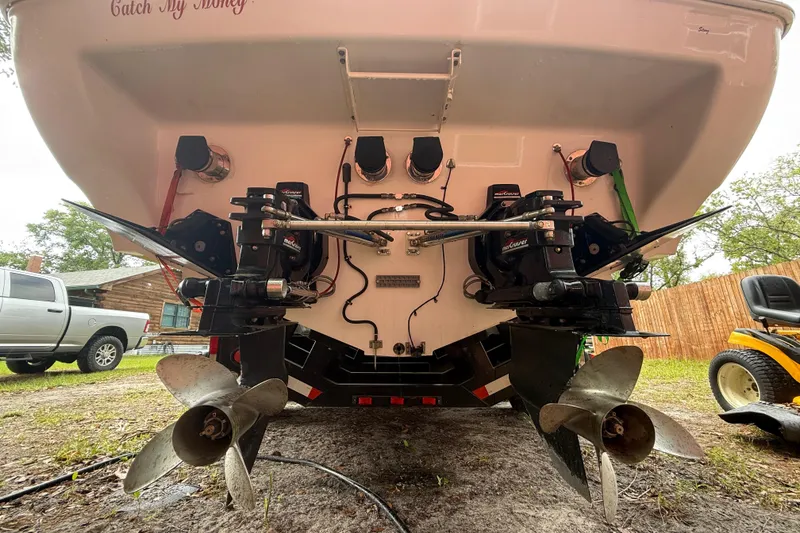 Slide: The Image of 1998 Donzi 33 ZX boat stern view with dual propellers and outboard motors. - 74