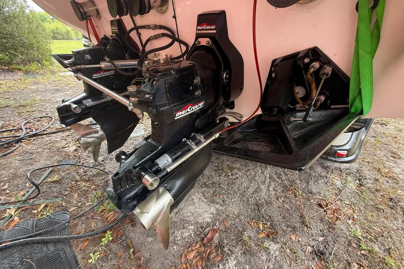 Slide: The Image of 1998 Donzi 33 ZX boat with dual MerCruiser outdrives on a grassy surface. - 76