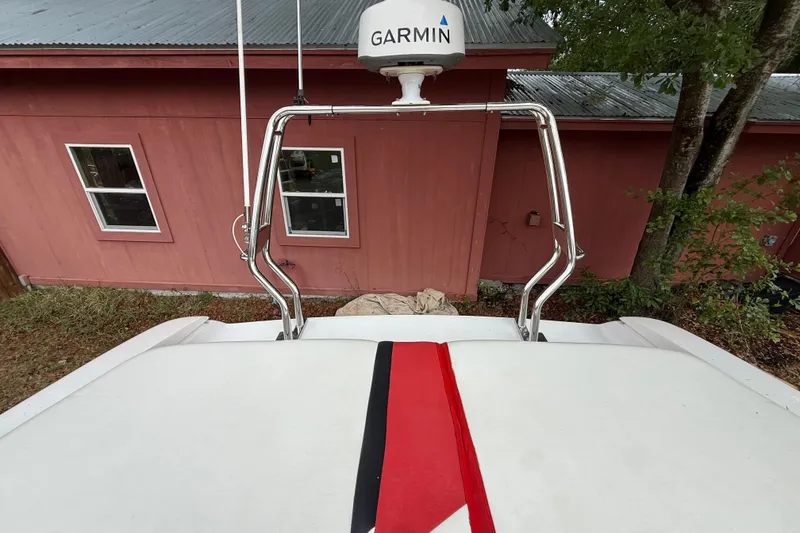 Slide: The Image of 1998 Donzi 33 ZX boat with Garmin radar, red stripe, near red building. - 77