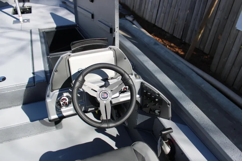Slide: The Image of 2026 Xpress H20 boat dashboard with steering wheel and control panel. - 13