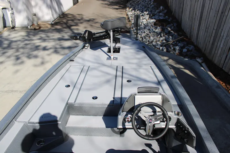 Slide: The Image of 2026 Xpress H20 boat interior with steering wheel and seating, parked on a driveway. - 4