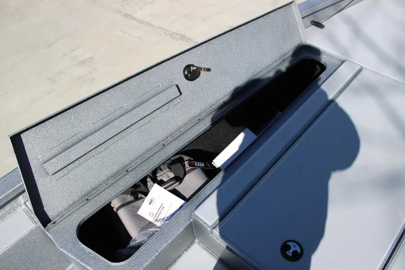 Slide: The Image of Open storage compartment on 2026 Xpress H20 boat, showing interior details and shadow. - 6