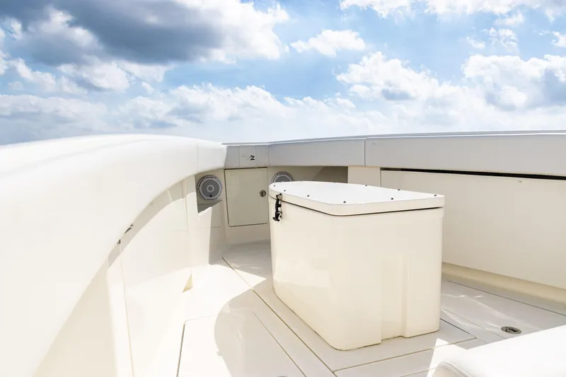 Slide: The Image of 2018 SeaVee 370Z boat deck with storage box under a cloudy sky. - 12