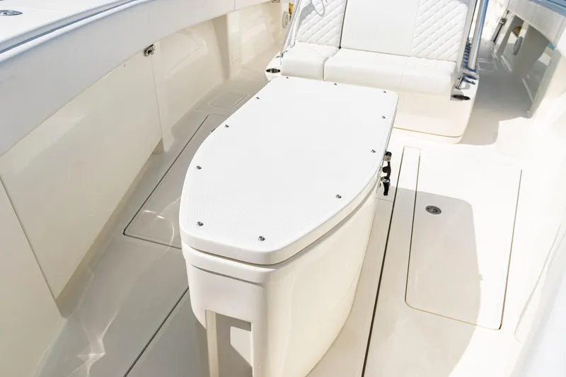 Slide: The Image of 2018 SeaVee 370Z boat interior with white seating and storage area. - 15