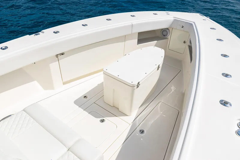 Slide: The Image of 2018 SeaVee 370Z boat interior with seating and storage, on calm blue water. - 18