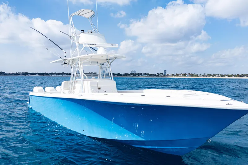 Slide: The Image of 2018 SeaVee 370Z boat on blue ocean under cloudy sky. - 2