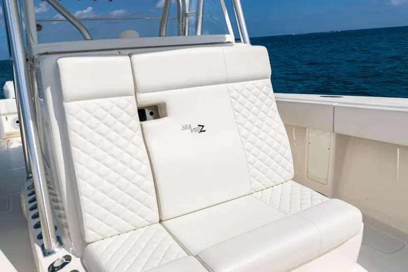 Slide: The Image of 2018 SeaVee 370Z boat with white quilted seating, ocean backdrop. - 21