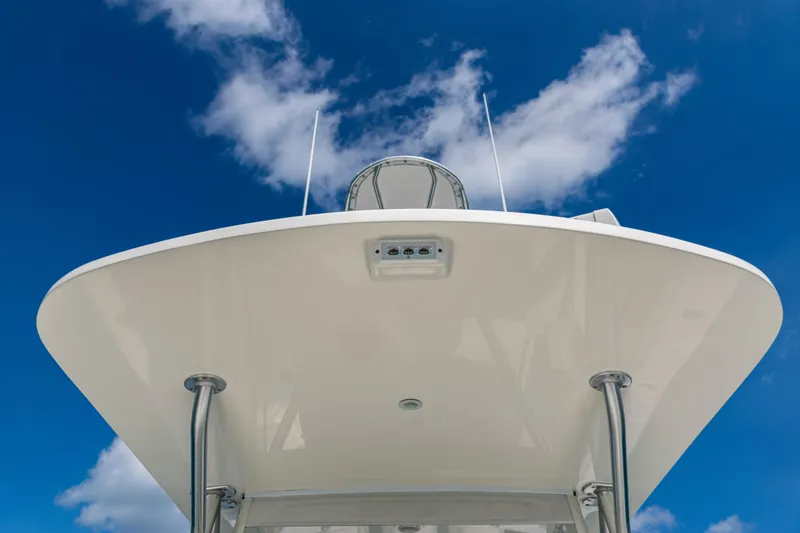 Slide: The Image of 2018 SeaVee 370Z boat against a bright blue sky with clouds. - 22
