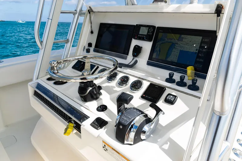 Slide: The Image of Control panel of 2018 SeaVee 370Z boat with navigation screens and steering wheel. - 25