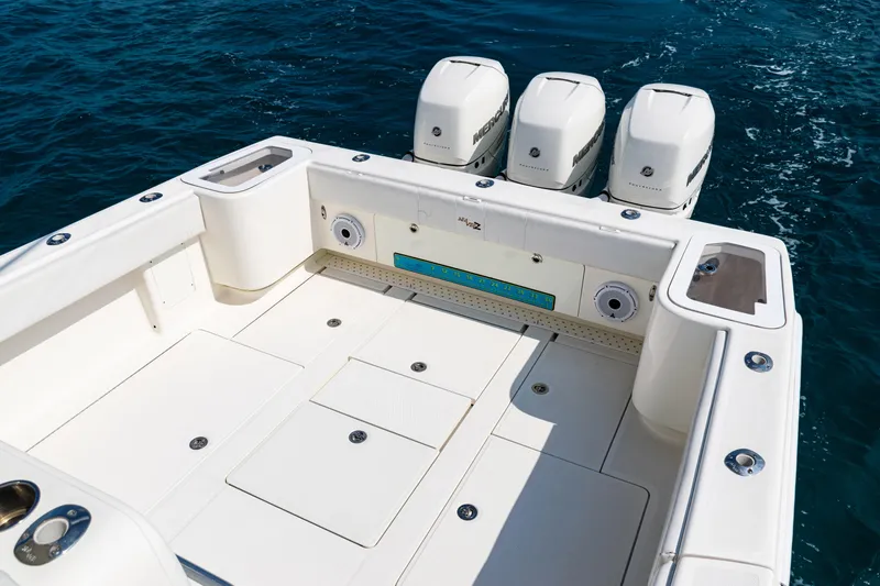 Slide: The Image of 2018 SeaVee 370Z boat deck with triple Mercury outboard engines on open water. - 33