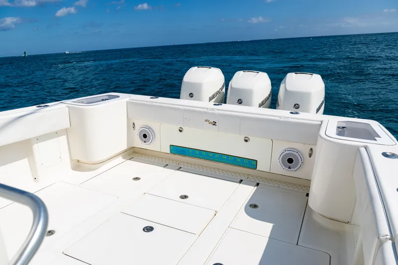 Slide: The Image of 2018 SeaVee 370Z boat deck with triple outboard motors on open ocean. - 34
