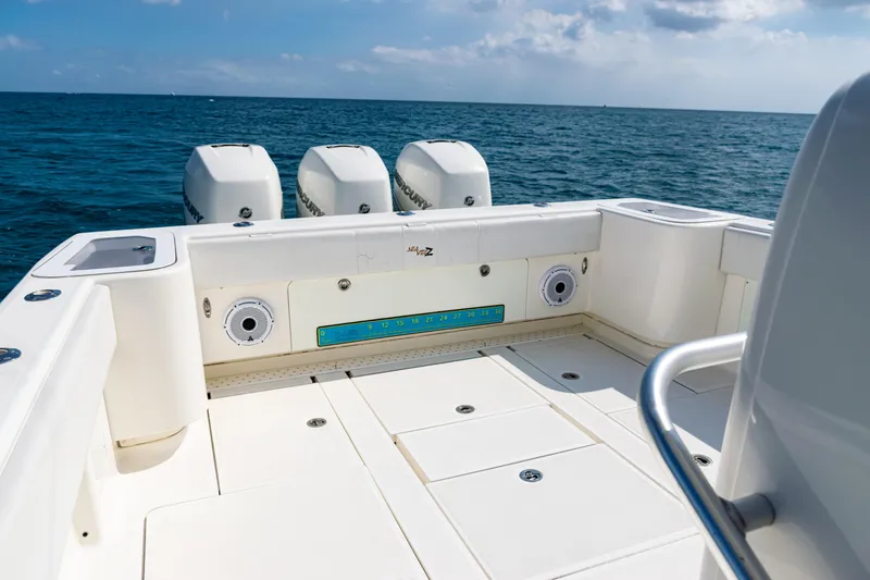 Slide: The Image of 2018 SeaVee 370Z boat deck with triple outboard motors on open sea. - 35