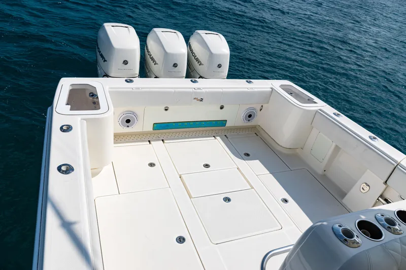 Slide: The Image of 2018 SeaVee 370Z boat deck with triple Mercury outboard engines on open water. - 36