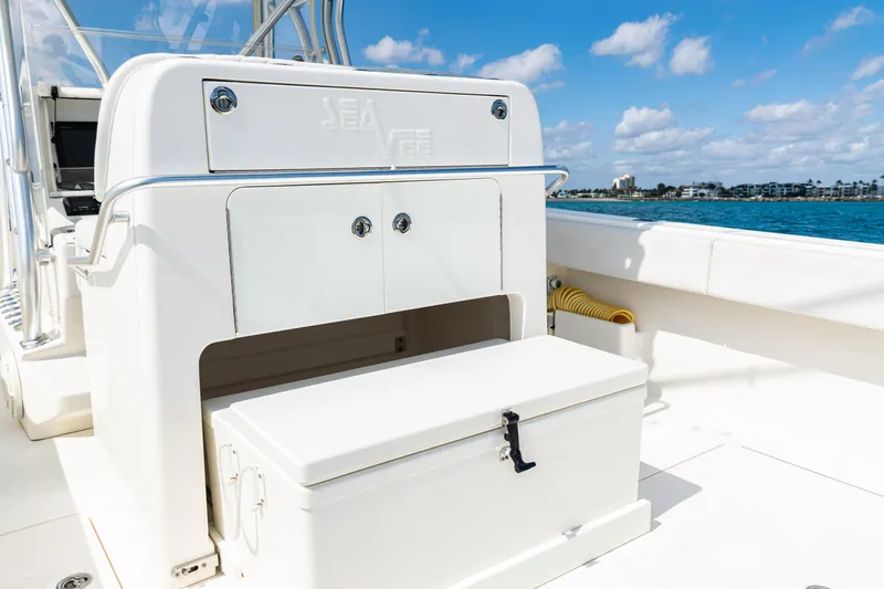 Slide: The Image of 2018 SeaVee 370Z boat interior with storage compartment, ocean view, and clear blue sky. - 40