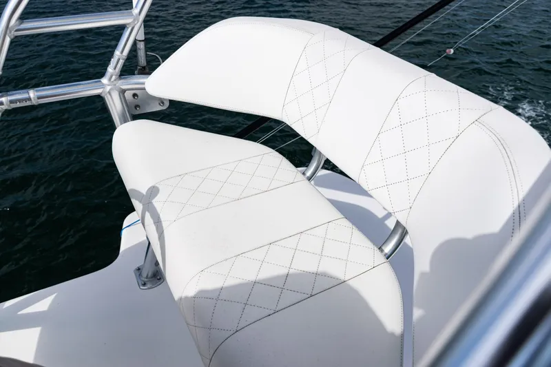 Slide: The Image of White cushioned seating on 2018 SeaVee 370Z boat, overlooking water. - 53