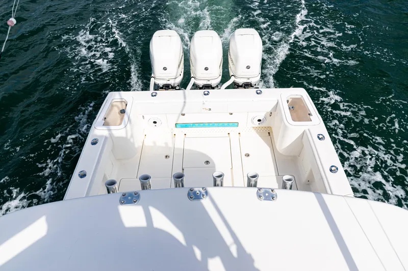 Slide: The Image of 2018 SeaVee 370Z boat with triple outboard engines on open water. - 54