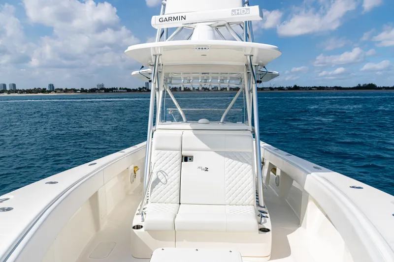 Slide: The Image of 2018 SeaVee 370Z boat on open water, featuring Garmin equipment and clear skies. - 55