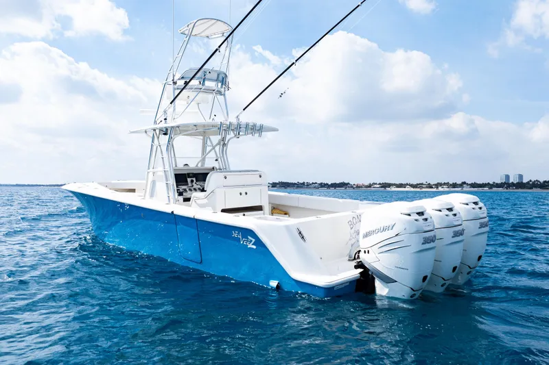 Slide: The Image of 2018 SeaVee 370Z boat with triple Mercury engines on open water. - 7
