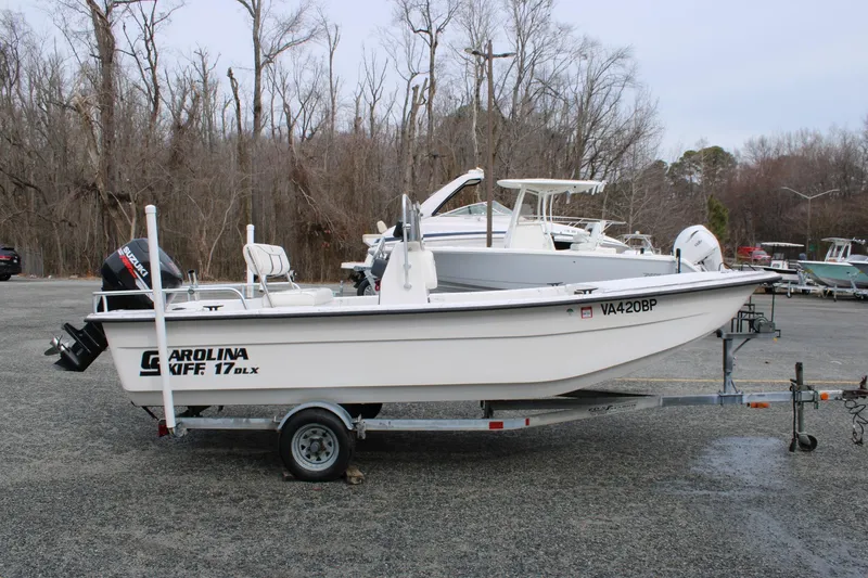 Slide: The Image of 2009 Carolina Skiff 17 DLX boat on trailer in parking lot, side view. - 0