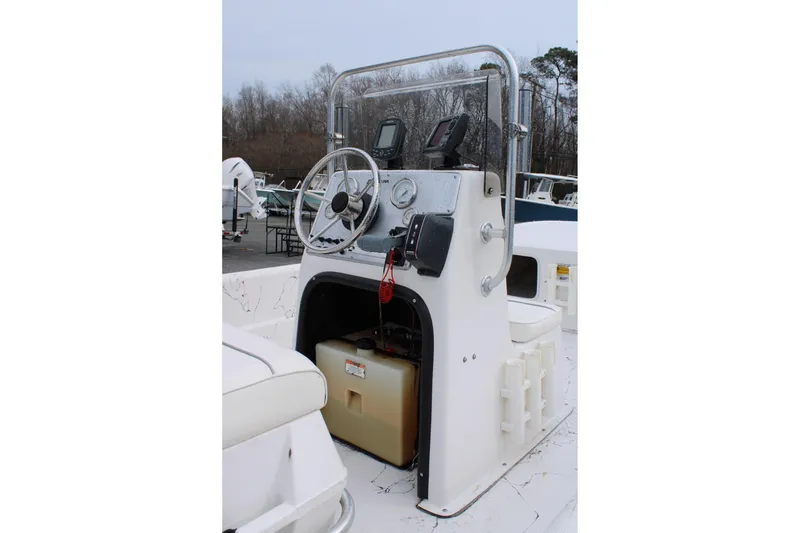 Slide: The Image of 2009 Carolina Skiff 17 DLX boat console with steering wheel and gauges. - 10