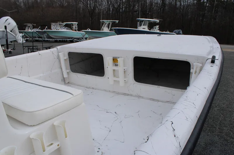 Slide: The Image of 2009 Carolina Skiff 17 DLX boat interior with seating and storage compartments. - 11